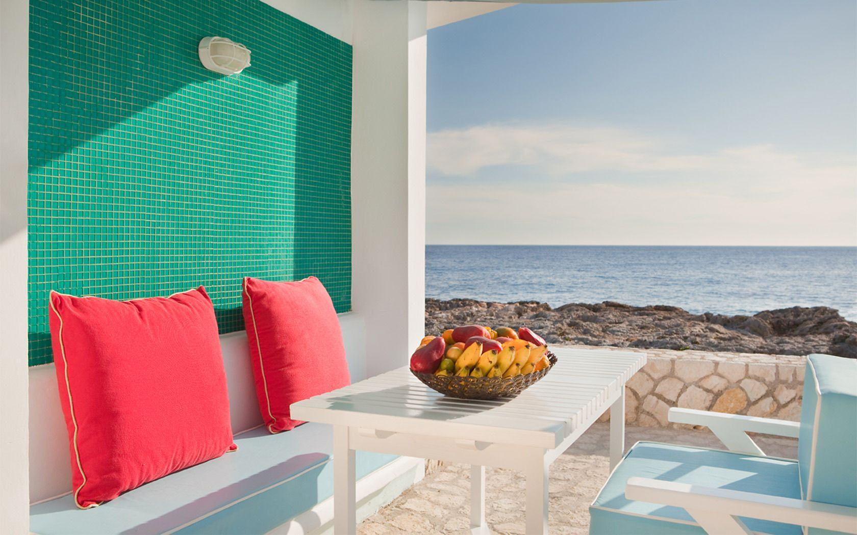 Seaside lounge with red cushions