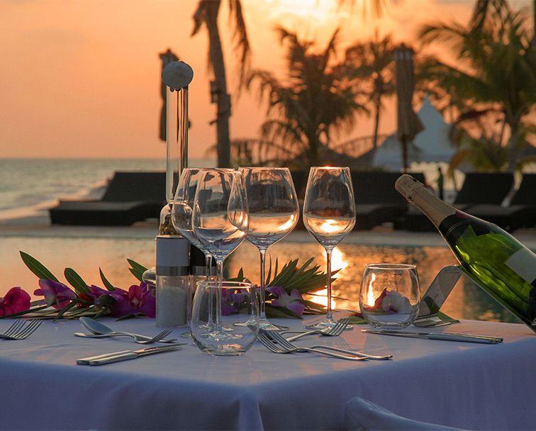 Table set by the sea at sunset