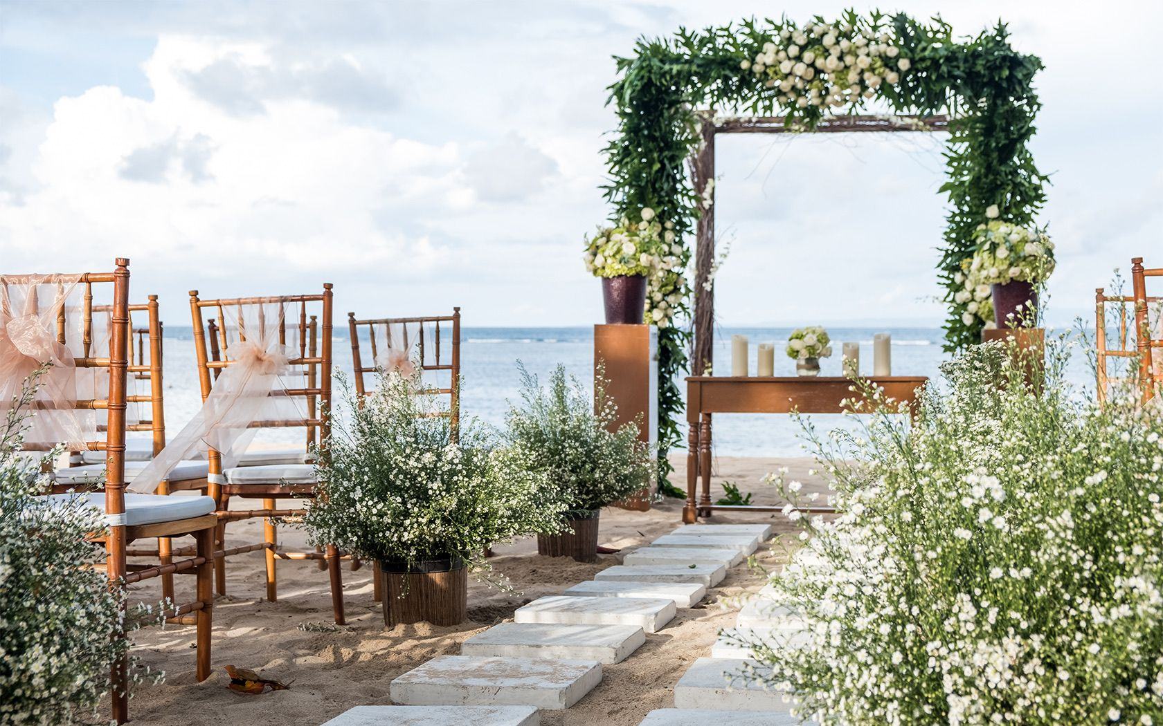A floral wedding arch facing the sea